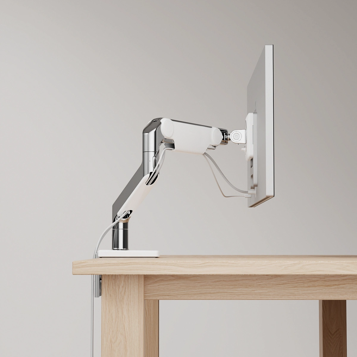 Humanscale M10 monitor arm. Close-up image of the arm mounted on a desk.