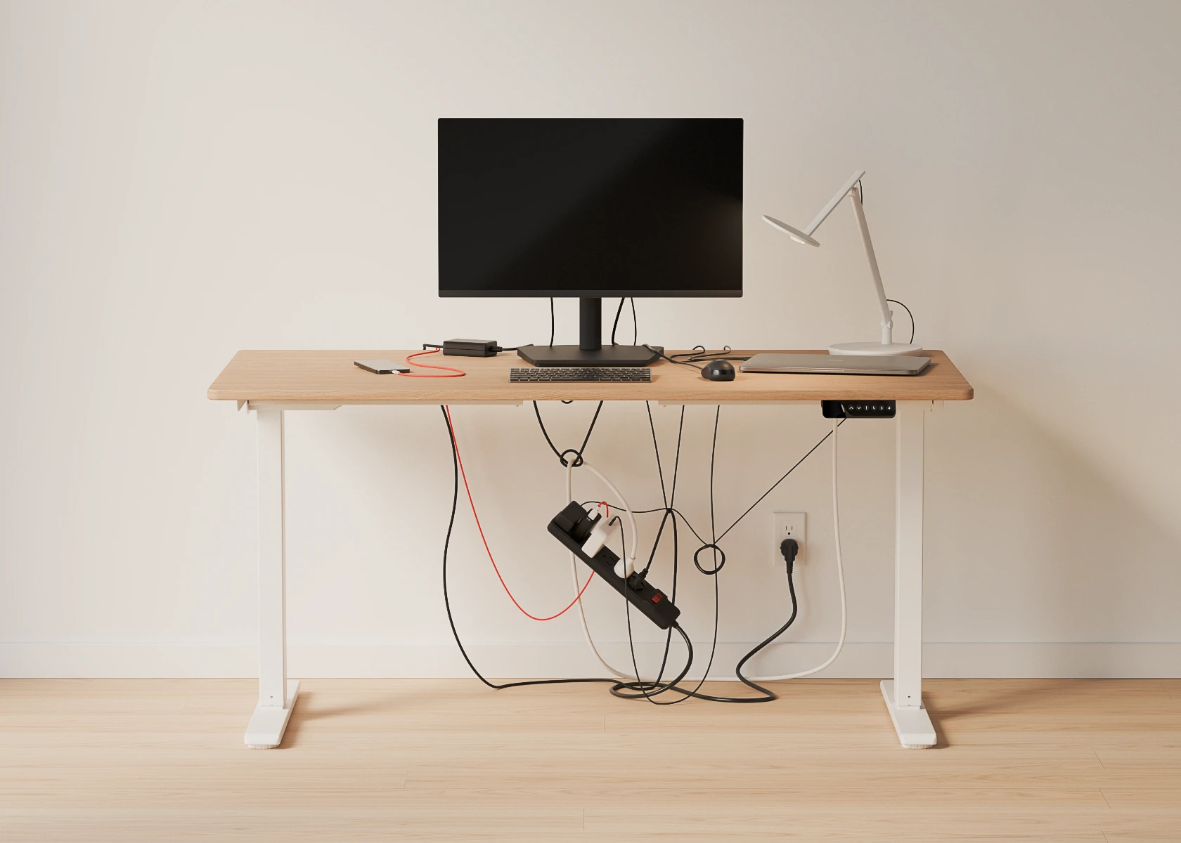 Humanscale NeatTech desk cable management. Image showing a cluttered before.